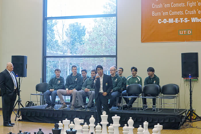 Coach Sadorra, in front of chess team members