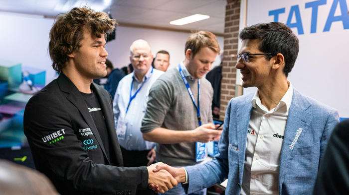 Carlsen shakes hands with Giri Photo by Lennart Ootes; Tata Steel Chess.