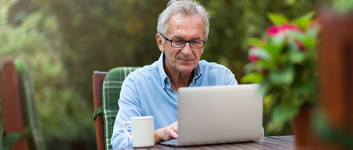 senior playing sparkchess on a laptop